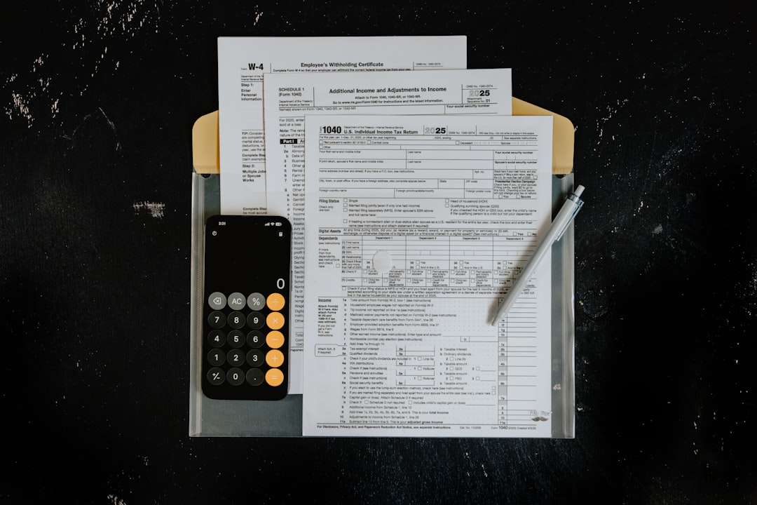 tax-forms-with-calculator-and-pen-on-dark-surface-7edddu99-8q